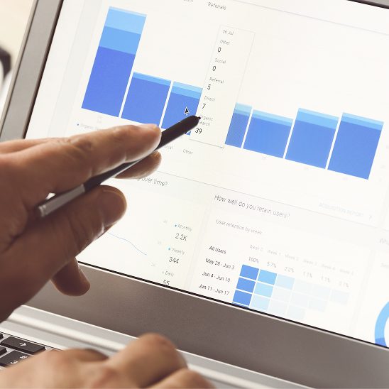 Person analyzing website analytics and traffic charts on a laptop for SEO